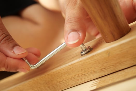 Fixing furniture with an Allen wrench at home photo