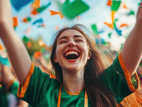 Excited fan celebrating at a sports event with colorful confetti photo