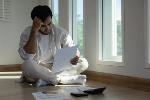 Stressed and headache man with large bills or invoices no money to pay to expenses and credit card debt. shortage, Financial problem, bankruptcy, mortgage, loan, bankrupt, poor empty wallet photo