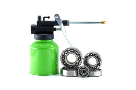 Grease gun lubricating ball bearings isolated on white background photo