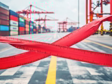 Shipping containers are restricted by red tape at busy port photo
