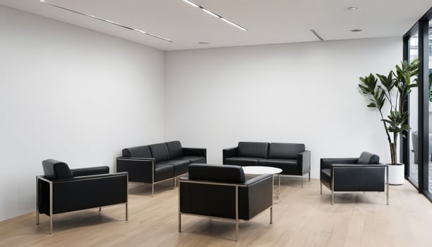 Bright, spacious office lobby with modern black sofas, large windows, natural light, fresh plants, creating an inviting, professional ambiance suitable for corporate reception areas. photo