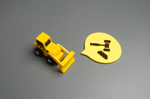Bulldozer and the symbol of the judge's hammer. Court decisions on demolition and construction photo