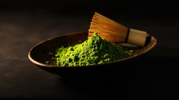 Matcha green powder in a wooden bowl on a black background photo