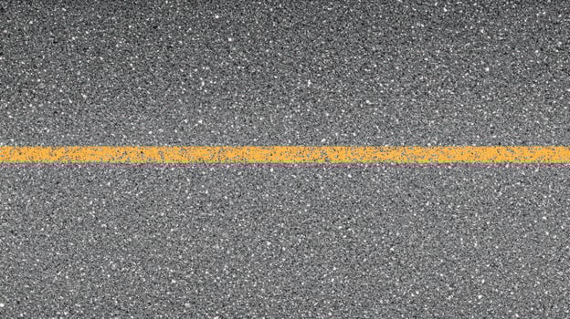 Single yellow line on asphalt road surface for transportation and urban design concepts photo