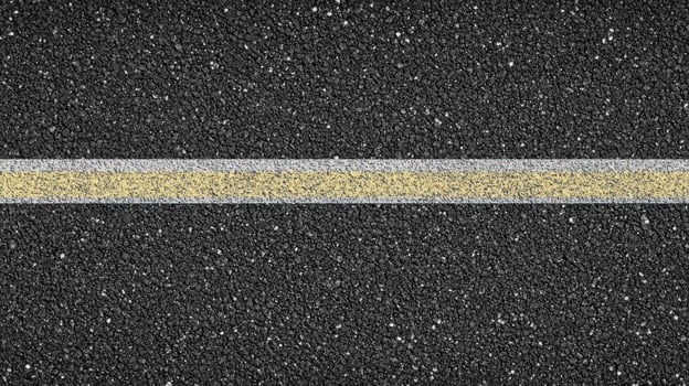 Close-up of asphalt road with yellow and white lines abstract texture concept photo