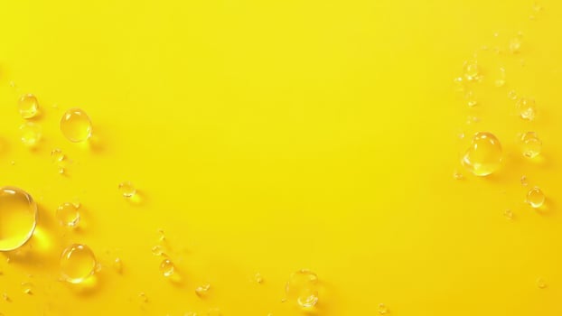 Oil drops on yellow background photo
