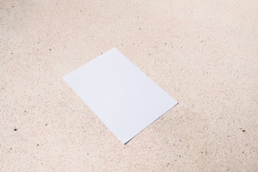 empty paper poster mockup on concrete stone floor or pavement outdoors photo