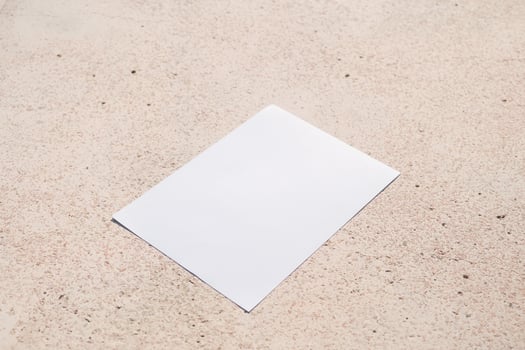 vertical paper poster mockup on concrete stone floor or pavement outdoors photo