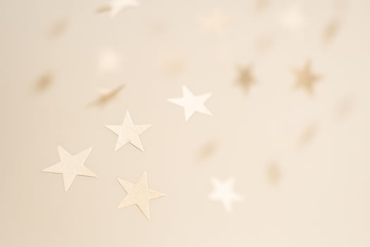 Soft Floating Paper Stars In Neutral Tones On Beige Background photo