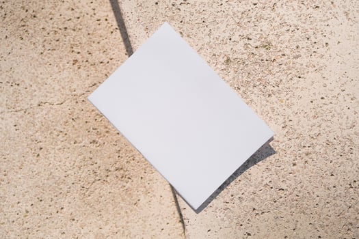 empty magazine mockup on stone floor or pavement outdoors photo