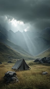 Solitary tent in a misty mountain valley beneath dramatic clouds, conceptual landscape photo