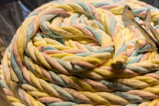 Colorful twisted candy showcasing pastel hues in a confectionery display at a local fair during a sunny afternoon photo