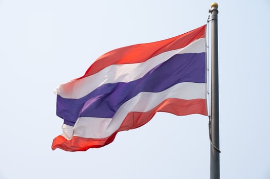 A Thailand national flag blowing by wind. photo