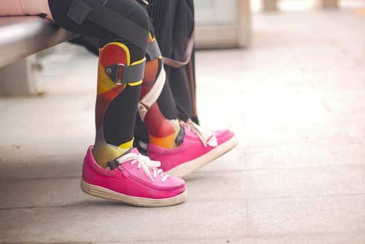 child with cerebral palsy leg orthosis outdoor photo