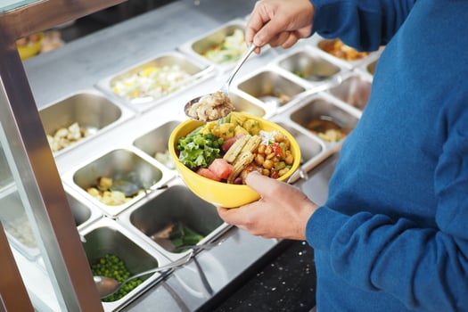 Enjoying a fresh salad bowl at a vibrant food station photo