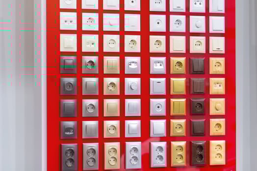 Electrical household sockets and switches on the stand in the store photo