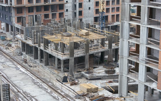 Construction crane on Housing. Construction site with buildings under construction. Tower cranes in action. Crane during formworks. Multi Storey Residential Buildings construction, aerial view. photo