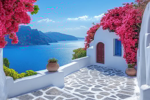 Whitewashed patio overlooking aegean sea with blooming bougainvillea in santorini, greece photo