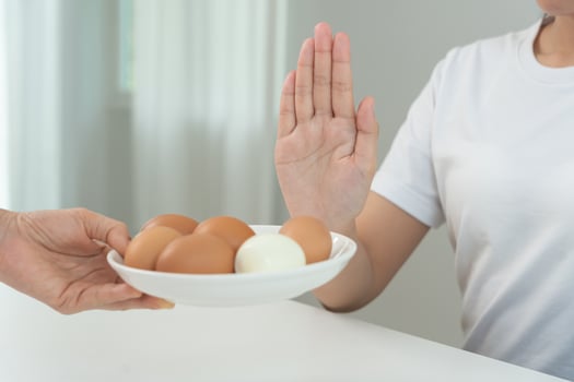 Egg allergy, ovalbumin allergy, women refuse eggs, swollen mouth, swollen eyes, itchy rash, hives, stuffy nose, difficult breathing, itchy eyes, stomach pain, nausea, vomiting, diarrhea photo