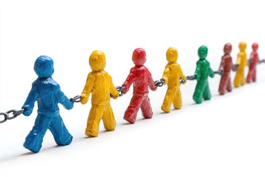 Colorful painted figurines holding a chain representing teamwork photo