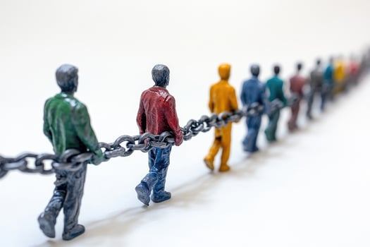 Diverse people holding a chain facing the same direction photo