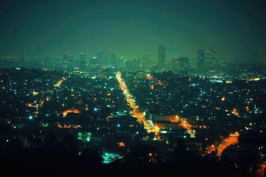 Dense urban cityscape illuminating night sky with glowing windows and street lights. photo