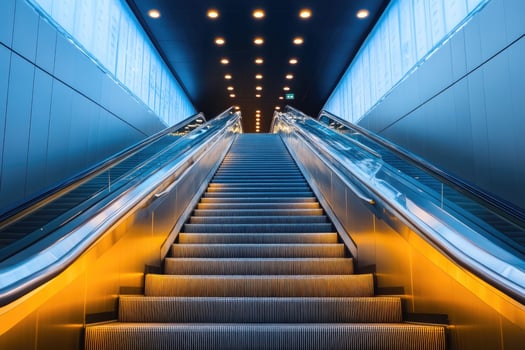 Empty escalator going up with orange and blue lights. photo