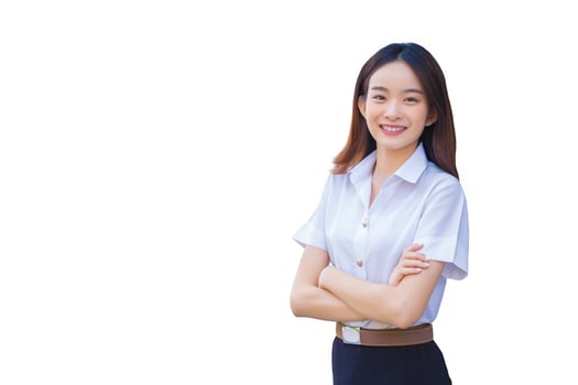Portrait of an adult Thai student in university student uniform. Asian beautiful girl standing smiling happily and confidently with her arms crossed on school white background. photo