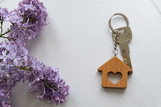 Real estate agent handing over house keys in hand photo
