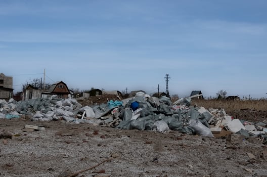 Pile of construction waste in front of an unfinished building. photo
