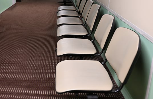 Empty hospital waiting room in lobby with reception counter at medical facility, used to help patients with appointments and healthcare insurance. Medical waiting area with front desk. photo