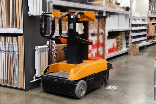 Hand pallet truck with the rice bag and plastic pallets with goods in the wholesale market. Unloading products for the supermarket. Trade and logistics. photo