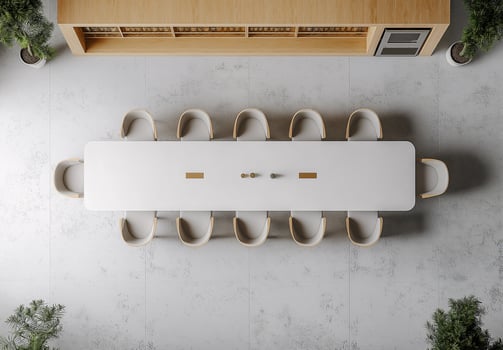 A long table with white chairs and a microwave in the background photo