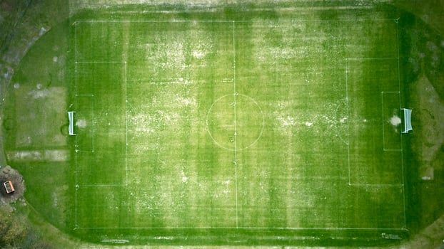 Soccer field with a few benches and a goal photo