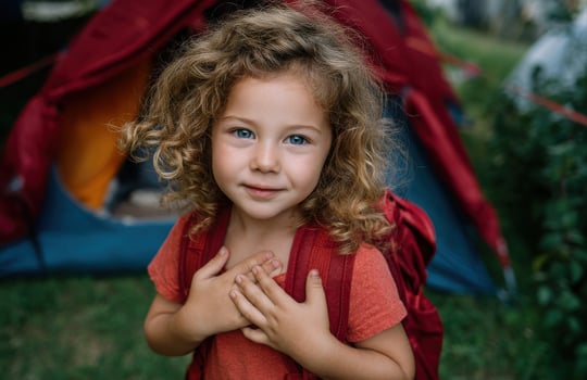 Happy Girl with Backpack at Colorful Outdoor Campsite photo
