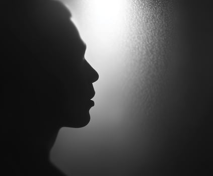 Man face is shown in a silhouette photo