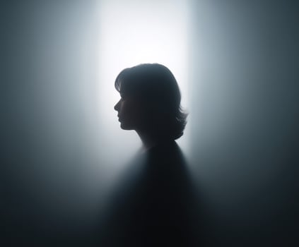 Woman's head is shown in a silhouette photo