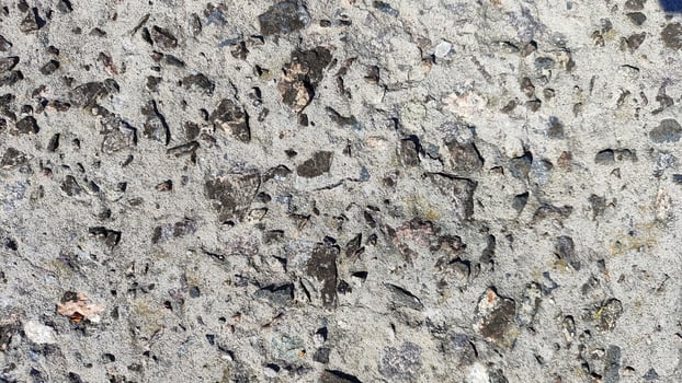 gray concrete with embedded pebbles, a natural abstract background texture for design, decor, and wallpaper photo