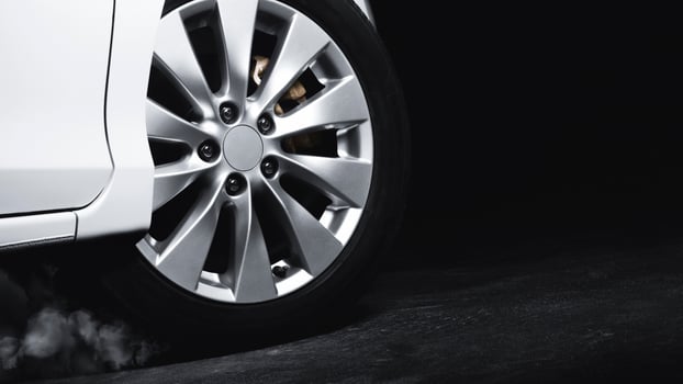 Luxury Metallic Car Wheel, Close-up of a alloy wheel with tire of car on black background. photo