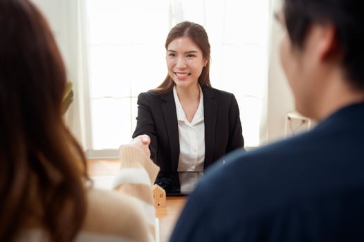 Professional Woman Shaking Hand With Clients in a Bright Office During a Business Meeting photo