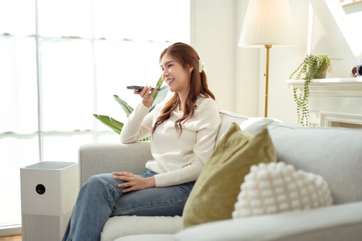 woman talking with AI via smartphone at home photo