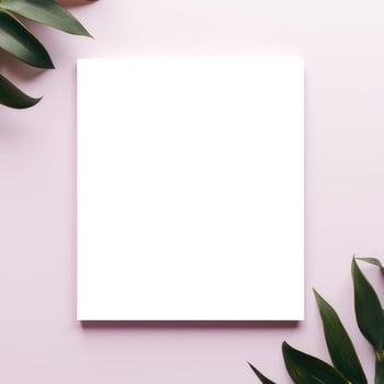 A white square surrounded by green leaves on a pink background photo