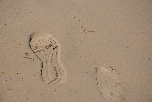 Footprints on sandy beach capturing tranquil summer vibes and seashore adventure, perfect for coastal escapes and nature retreats. Digital nomad lifestyle. Remote work photo