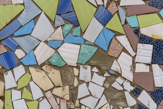 Mosaic of multicolored pieces of broken tiles. photo