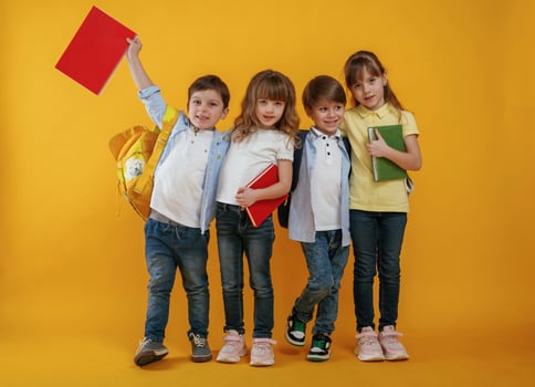 Kids are together, against yellow background photo