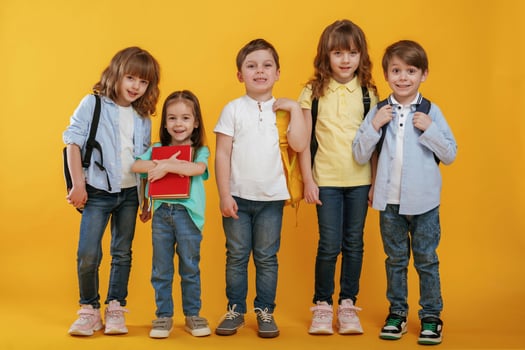Standing, and, posing. Kids are together against yellow background photo
