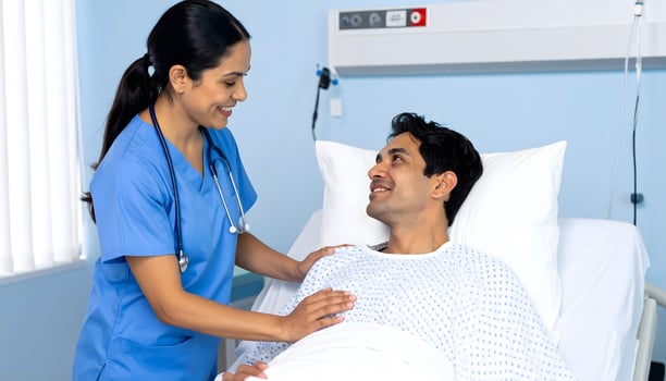 A Latin American nurse providing care and comfort to a patient in a hospital setting photo