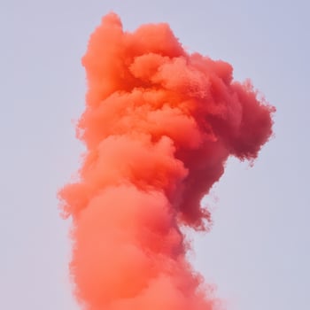 Bright orange smoke rising into the clear sky photo