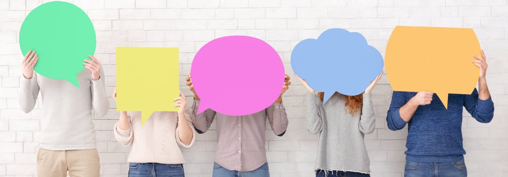 Friends holding speech bubbles with copy space over white wall, crop photo